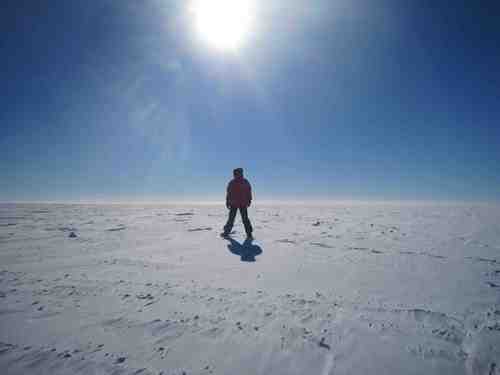 Looking away from the station with Brad standing under the sun.  The horizon basically looks like this in every direction; the South Pole is very flat and featureless. 